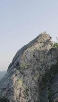 Majestic sunset in the mountains landscape. Lonely tree hanging from rocks in the mountains. Massive rocks and view to the sky during summer time video