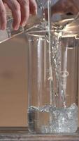Male researcher carrying out scientific research in a lab. Flasks with liquids in a lab. Liquid in the flask changes color video