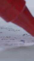 A red marker writes on a sheet of paper. Close-up. Marker Tip. Red marker with shadow video