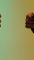Eastern man secretly takes a piece of gold nugget from another man and they make a fist bumping gesture, making a deal concept. Stock. Man taking piece of gold ore from hands of another man. video