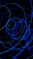 Abstract glowing dots forming tunnel of blue circles. Animation. 3D circles of small particles moving one by one on black background, seamless loop. video