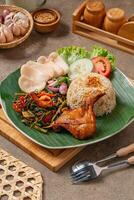 Simangunsong rice is a combination of stir-fried rice with shrimp paste and fried chicken photo