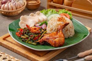 Simangunsong rice is a combination of stir-fried rice with shrimp paste and fried chicken photo