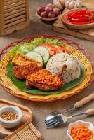 Simangunsong rice is a combination of stir-fried rice with shrimp paste and fried chicken photo