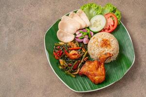 Simangunsong rice is a combination of stir-fried rice with shrimp paste and fried chicken photo