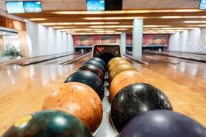 Bowling is a target sport and recreational activity in which a player rolls a ball toward pins photo