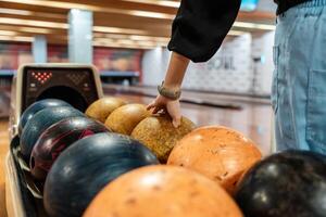 Bowling is a target sport and recreational activity in which a player rolls a ball toward pins photo