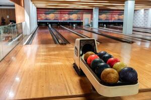 Bowling is a target sport and recreational activity in which a player rolls a ball toward pins photo