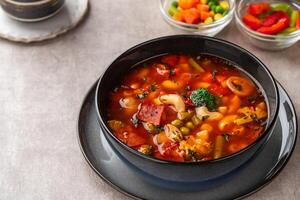 Minestrone Soup is a thick soup of Italian origin made with vegetables, often with the addition of pasta or rice. photo