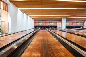Bowling is a target sport and recreational activity in which a player rolls a ball toward pins photo