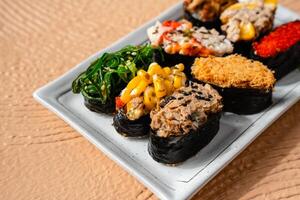 sushi is a Japanese dish of prepared vinegared rice, usually with some sugar and salt, accompanied by a variety of ingredients such as seafood, often raw and vegetables. photo