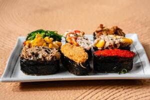 sushi is a Japanese dish of prepared vinegared rice, usually with some sugar and salt, accompanied by a variety of ingredients such as seafood, often raw and vegetables. photo