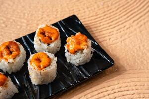 sushi is a Japanese dish of prepared vinegared rice, usually with some sugar and salt, accompanied by a variety of ingredients such as seafood, often raw and vegetables. photo