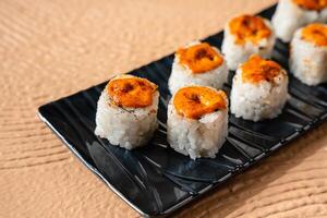 sushi is a Japanese dish of prepared vinegared rice, usually with some sugar and salt, accompanied by a variety of ingredients such as seafood, often raw and vegetables. photo