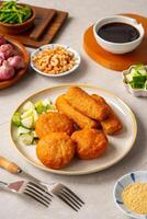Pempek is a savoury Indonesian fishcake delicacy, made of fish and tapioca from Palembang. Pempek is served with sweet and sour sauce. photo