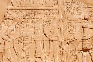EGYPT, LUXOR - MARCH 01, 2019 ancient Egyptian hieroglyphs, drawings and inscriptions on the walls and columns in the temple of Karnak in Luxor photo