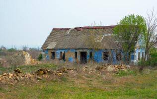 Abandoned old empty rural house that collapses from time to time, Ukraine photo