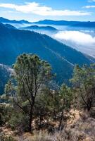 Beautiful mountain scenery on the background of clouds, layers of mountains on the horizon, Sierra Nevada Mountains, California, USA photo