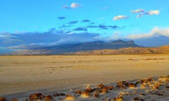Desert at sunset and thunderclouds against the backdrop of the Guadalupe Mountains in New Mexico photo