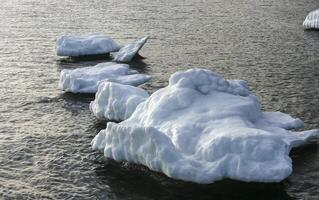 Iced rocks and stones near the shore in the Black Sea at the end of winter photo