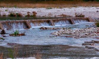 Artificial dam on the rivers, a stream of water in the form of a small waterfall, Texas, Garner State Park, USA photo
