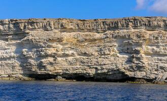 High Coastal cliffs from layered Pontic limestone in the western Crimea, Tarkhankut photo