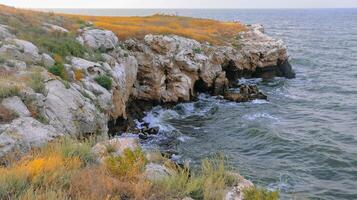 The steep stone coast of the Black Sea from Pontic limestones at Kazantip, Eastern Crimea photo