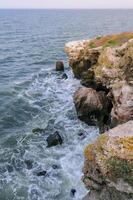 The steep stone coast of the Black Sea from Pontic limestones at Kazantip, Eastern Crimea photo