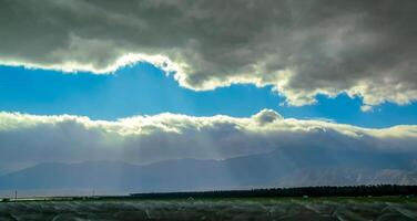 The sun's rays break through the thick clouds over the mountains, State park ANZA-BORREGO DESERT photo