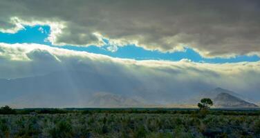 The sun's rays break through the thick clouds over the mountains, State park ANZA-BORREGO DESERT photo