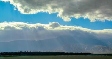 The sun's rays break through the thick clouds over the mountains, State park ANZA-BORREGO DESERT photo