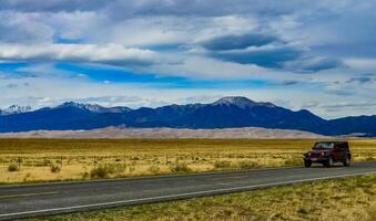 Great Sand Dunes with mountains in the background, Colorado, US photo