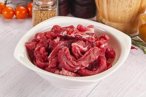 Raw beef meat - sliced strips photo