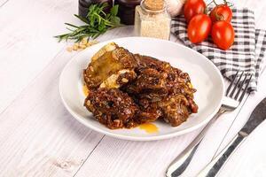Prepared tasty beef ribs with sauce photo