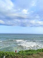 A calm atmosphere on the beach with fresh air and the sound of waves crashing against the rocks photo