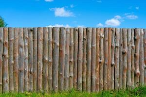 Log wooden fence. The texture of the old wooden fence. Wooden vintage background. photo