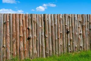 Log wooden fence. The texture of the old wooden fence. Wooden vintage background. photo