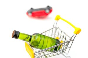 Selling alcohol in a store. Green bottle in a supermarket cart. Drink in a green bottle. Car accident. photo