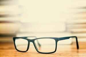 Glasses on the background of books. Symbol of knowledge, science, study, wisdom. photo