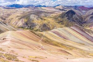 Beautiful colours of the Palccoyo Rainbow Mountain near Cusco, Peru at an elevation of almost 5000m. The layers contain different minerals causing the different colours. photo