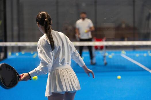 Young Girls Is Playing Padel on an Court. photo