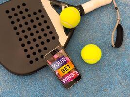 padel tennis and sports betting on a smartphone. Concept of sports bet photo