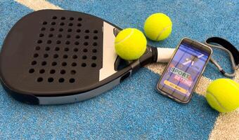 padel tennis racket and smartphone with betting photo