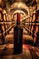 Red wine bottle mock up on on top of an old barrel, rows of barrels inside a winery or castle-like building, copy space and place for logo video
