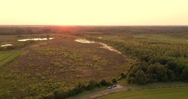 aerial view of a beautiful sunset over a green field video