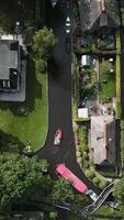 Aerial view of boats sailing through small canals in Giethoorn The Netherlands video
