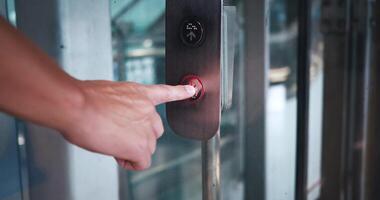 Finger Pressing Elevator Button Down in Office Center or Hotel. Mans hand presses elevator button to move down in modern building at the mall or airport. video