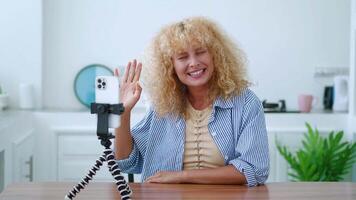 Pleasant woman, cutely smiling a cheerful toothy smile while talking with her interlocutor by link. Freelancer having a dialogue with clients. Smart student studying online during quarantine video
