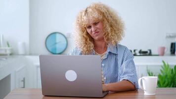 Charming Caucasian woman feels baffled having misunderstanding while working on laptop, learn new software, feeling physical or mental exhaustion caused by overwork or stress. video