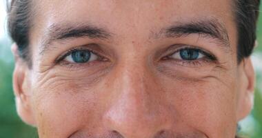 Close-up face portrait of a handsome blue eyed man with Caucasian appearance looking calm, smiling, posing with beautiful insightful look at the camera. Cropped view. Headshot. video